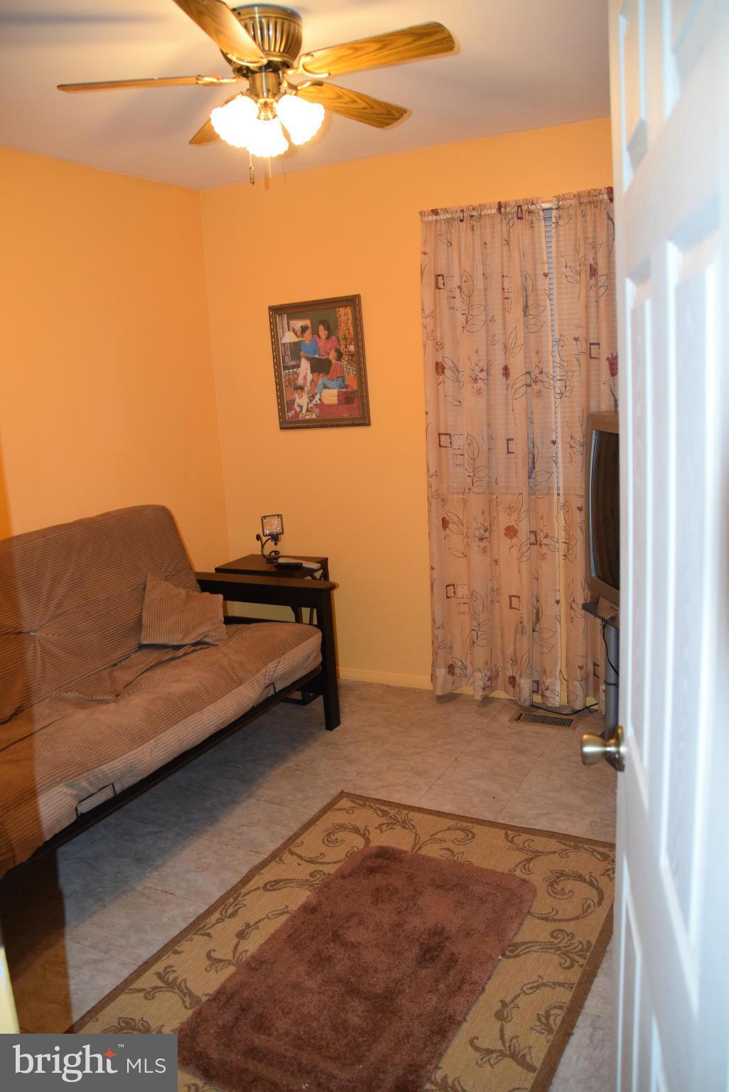 4012 Winlee Road Randallstown, MD 21133 - Photo 8 of 22 a view of a livingroom with furniture and a ceiling fan