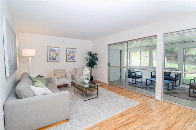 a living room with furniture and wooden floor