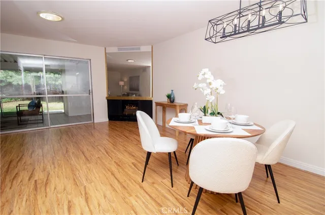a dining room with furniture and wooden floor