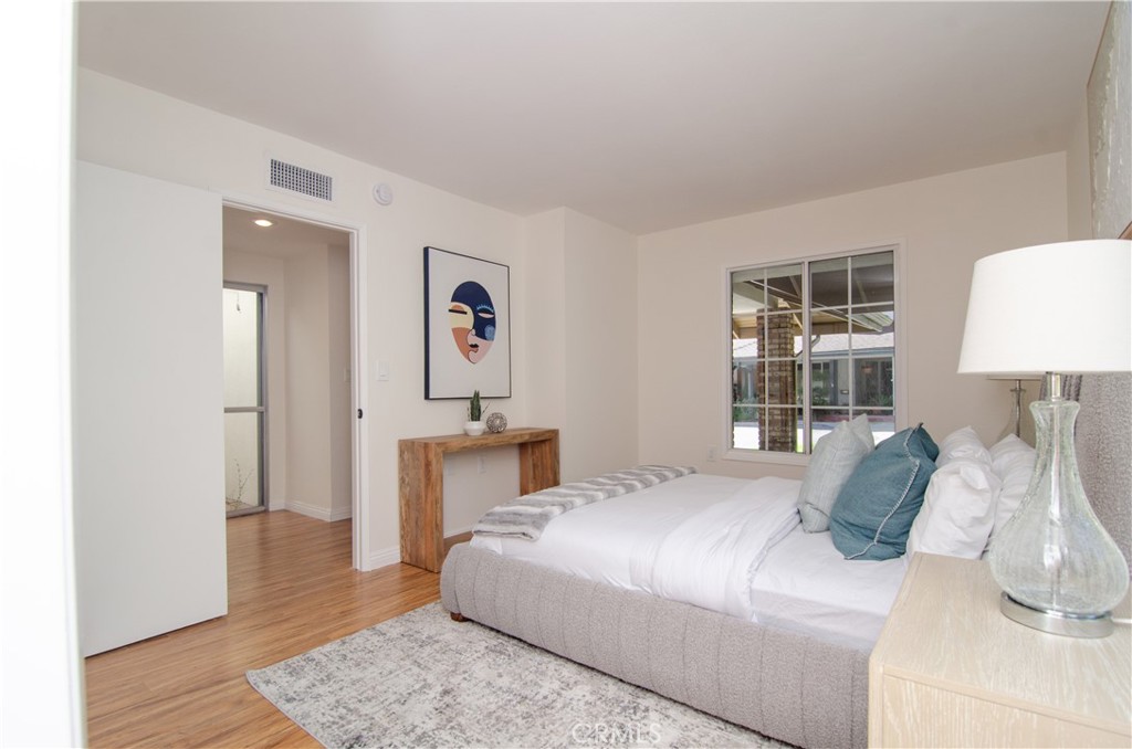 26701 Oak Branch Circle Newhall, CA 91321 - Photo 28 of 44 a bedroom with a bed and wooden floor