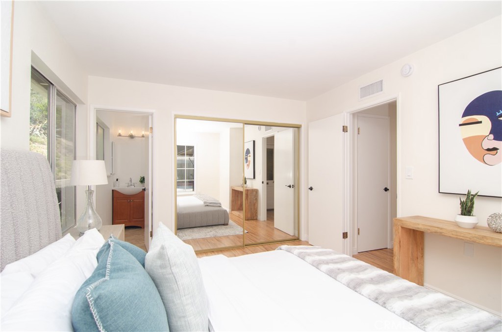 26701 Oak Branch Circle Newhall, CA 91321 - Photo 29 of 44 a spacious bedroom with a bed and glass walk in closet