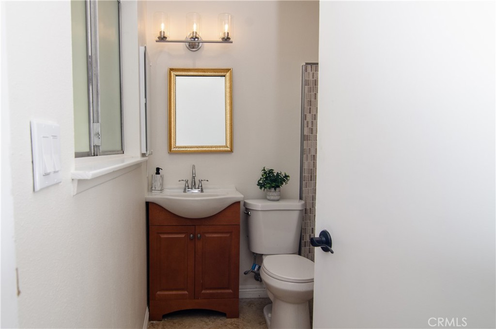 26701 Oak Branch Circle Newhall, CA 91321 - Photo 31 of 44 a bathroom with a sink a toilet and mirror