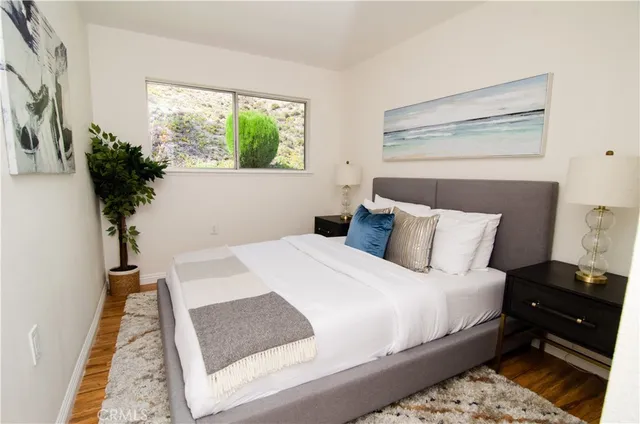 a bed sitting in a bedroom next to a window