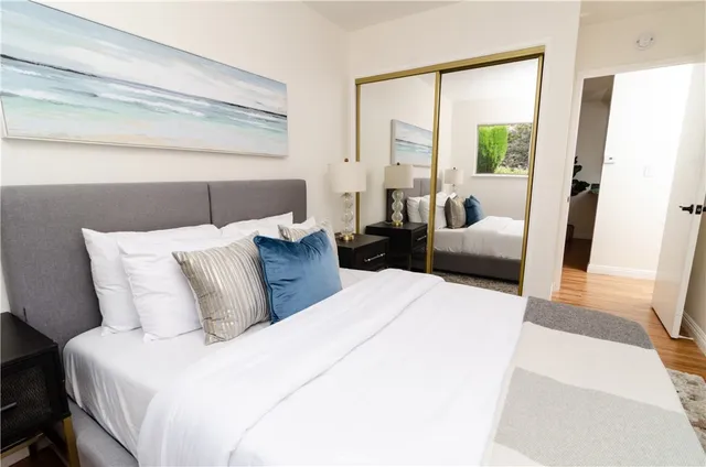 a bedroom with a large bed and a large window