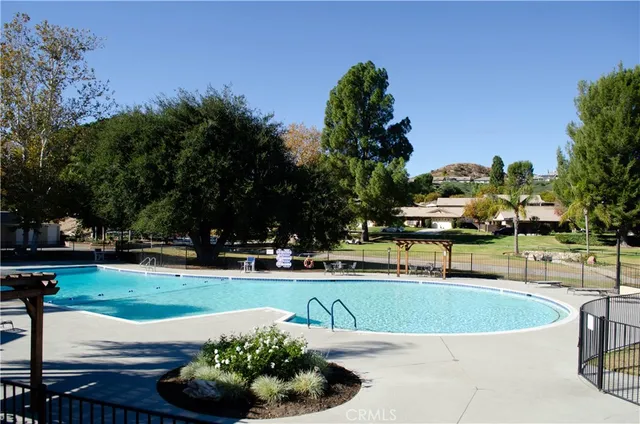 a view of a swimming pool with an outdoor space and seating area