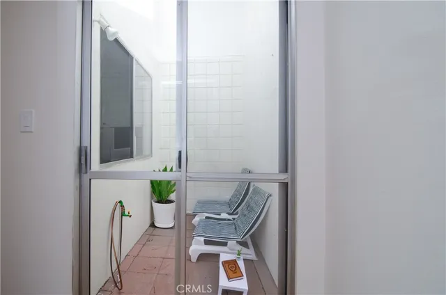 a view of a hallway with chair and table