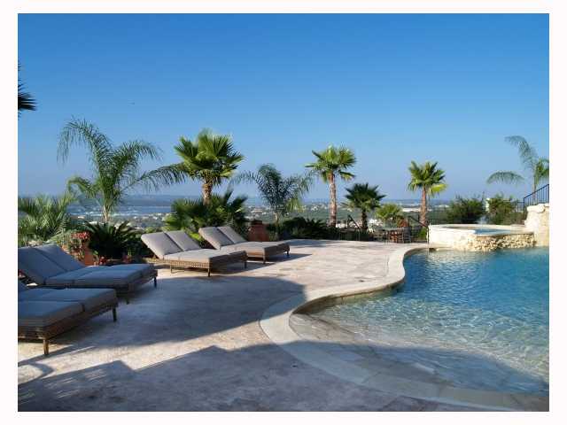 a view of a backyard and swimming pool