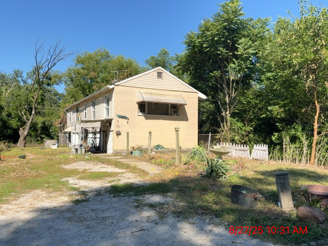 a view of a white house with a yard
