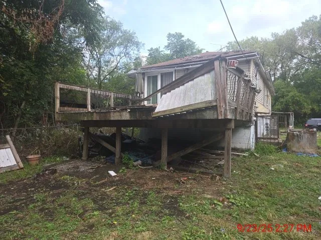 a backyard of a house with table and chairs