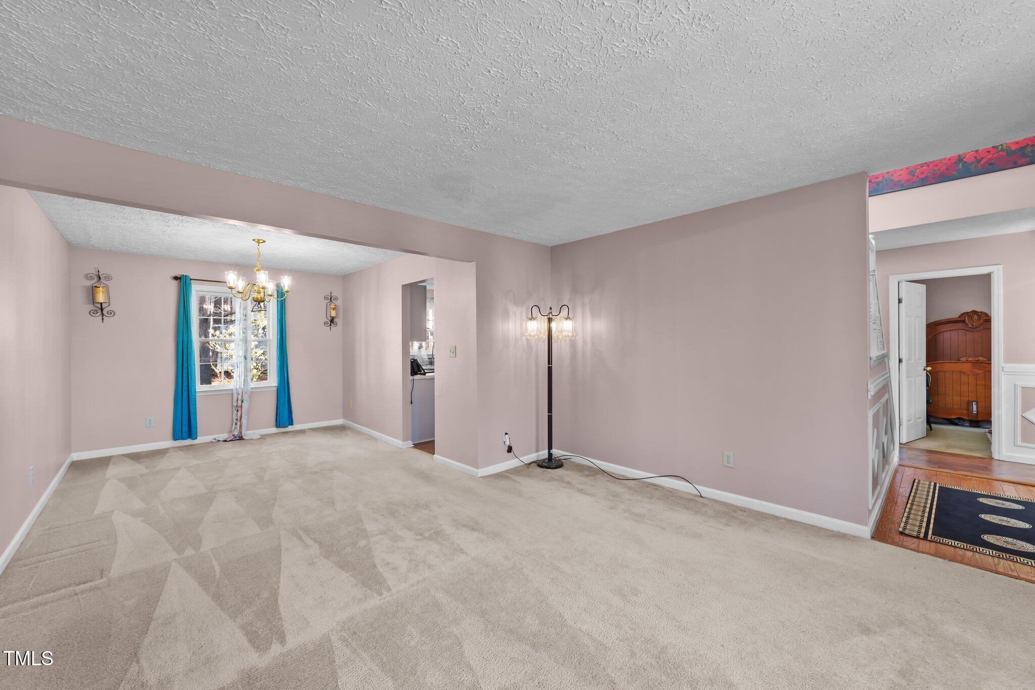 300 Pate Street Apex, NC 27502 - Photo 14 of 38 a view of a livingroom with an empty space and a workspace