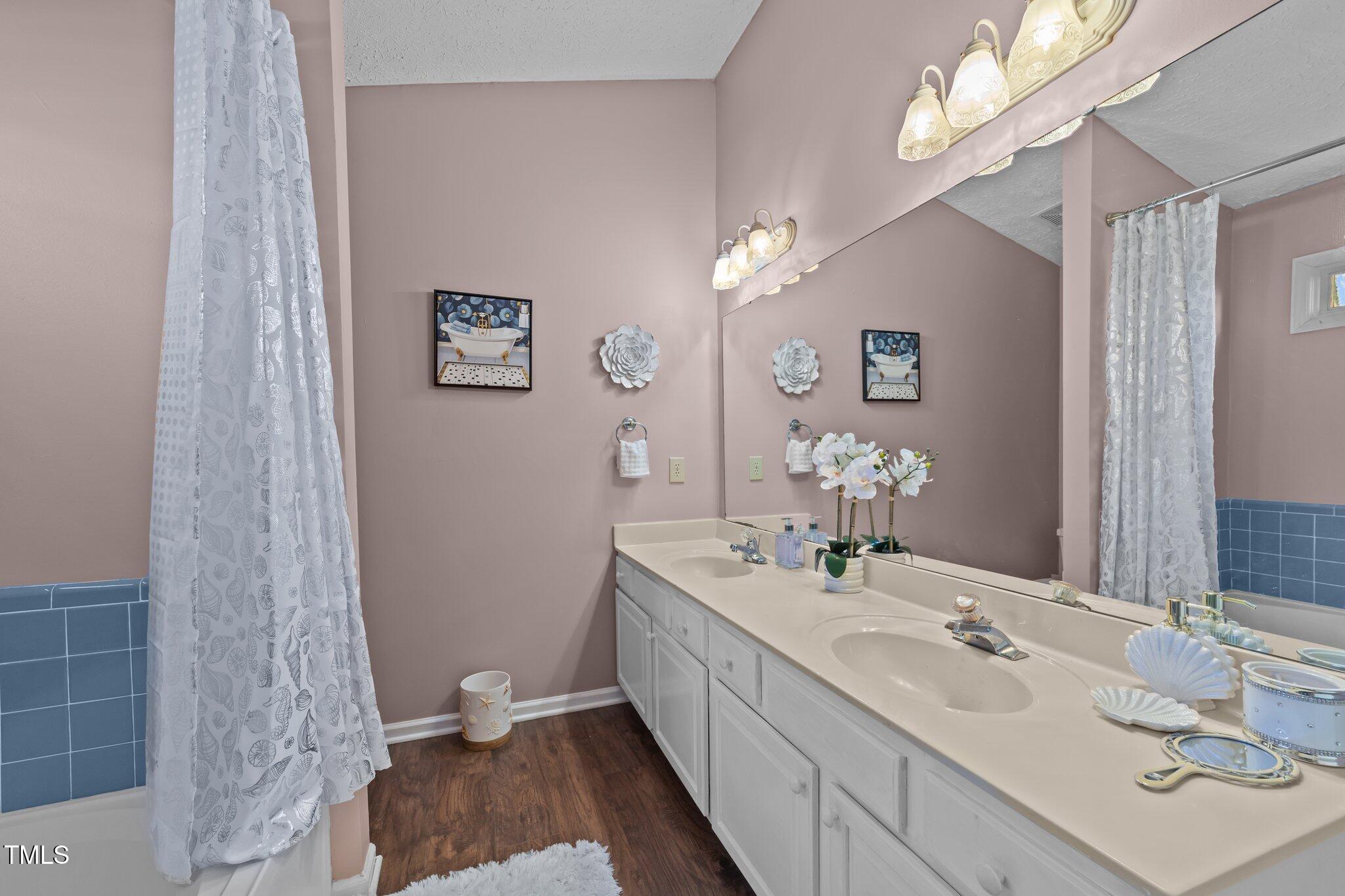 300 Pate Street Apex, NC 27502 - Photo 18 of 38 a bathroom with a double vanity sink and a mirror