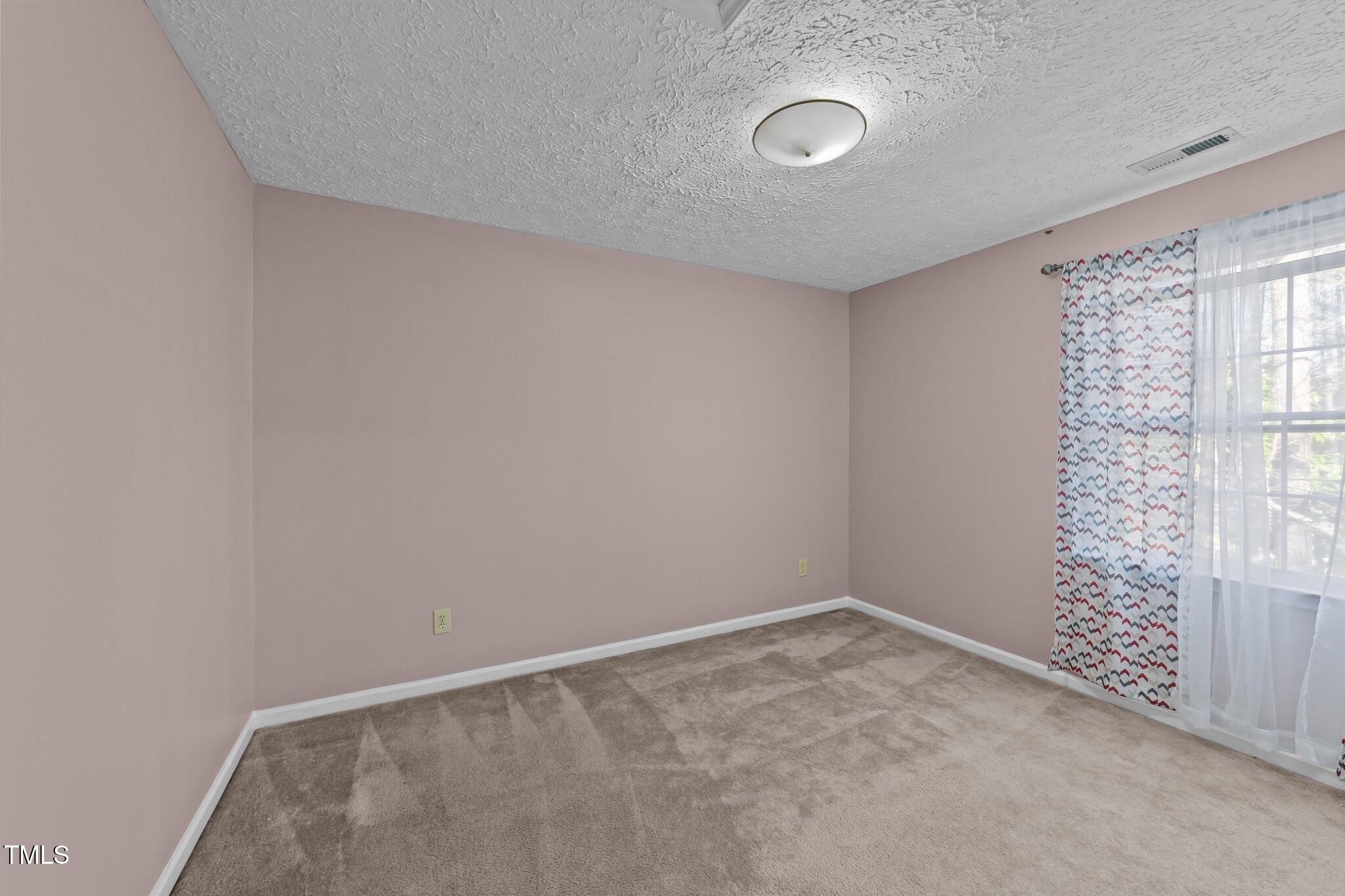 300 Pate Street Apex, NC 27502 - Photo 21 of 38 a view of an empty room with a window