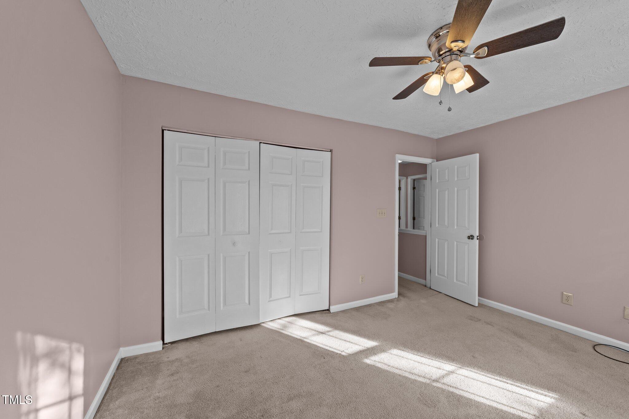 300 Pate Street Apex, NC 27502 - Photo 24 of 38 a view of a livingroom with a ceiling fan and window