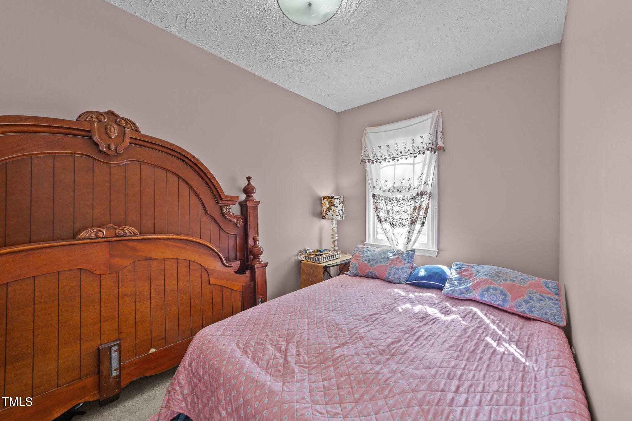 300 Pate Street Apex, NC 27502 - Photo 26 of 38 a bedroom with a bed and a window