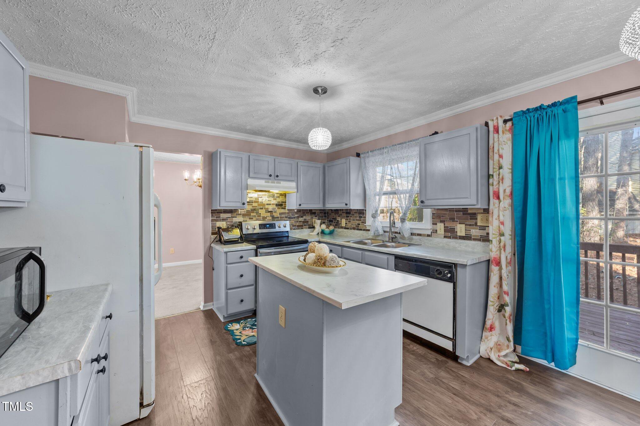 300 Pate Street Apex, NC 27502 - Photo 4 of 38 a kitchen with a sink stove and refrigerator