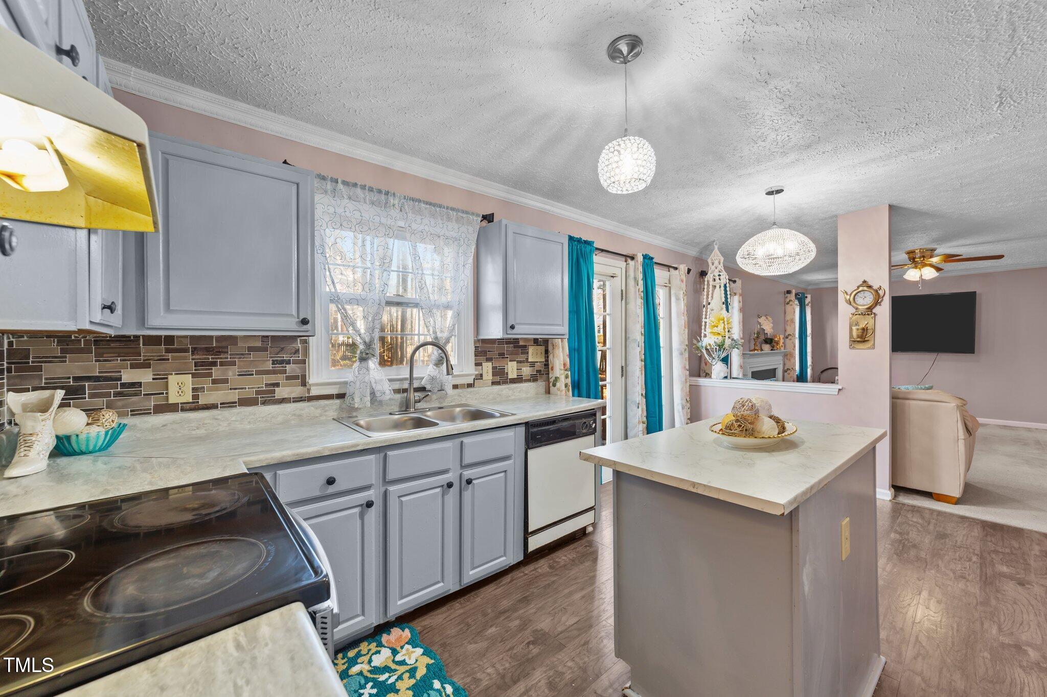 300 Pate Street Apex, NC 27502 - Photo 6 of 38 a kitchen with a sink stove and cabinets