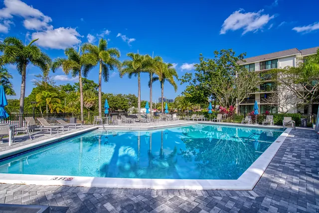 a view of a patio with couches and table and chairs and potted plants