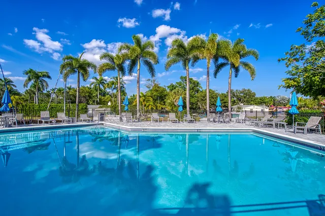 a childrens park with lots of swings slides and swimming pool