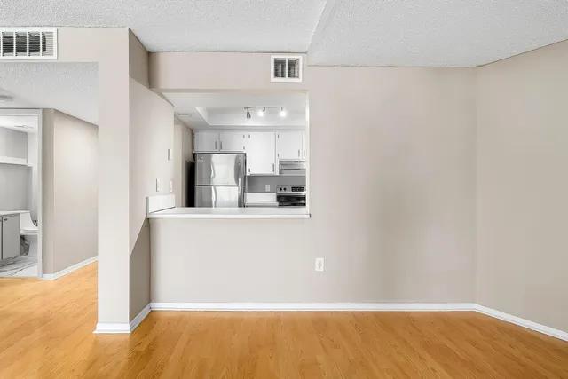 a kitchen with stainless steel appliances granite countertop a sink and a refrigerator