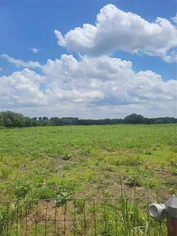 a view of a lake with a yard
