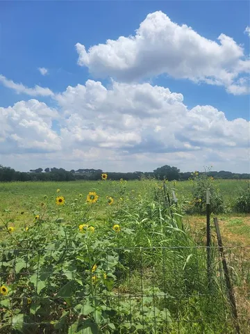 a view of a livingroom with workspace and a window