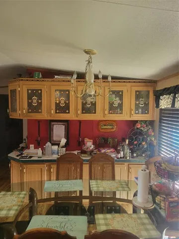 a living room with lots of furniture and kitchen view