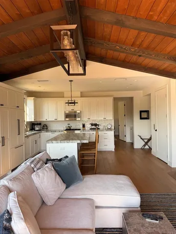 a living room with furniture and kitchen view