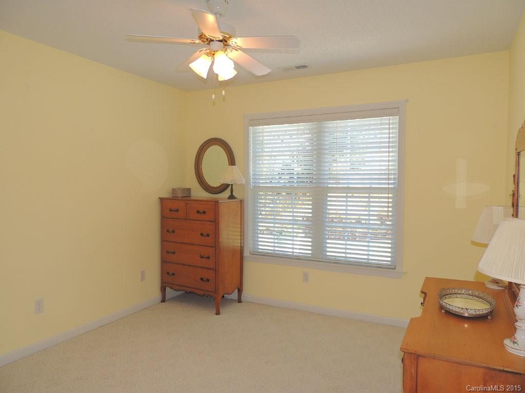 112 Forest Berry Road Fletcher, NC 28732 - Photo 13 of 21 a view of a bedroom with a window and a ceiling fan