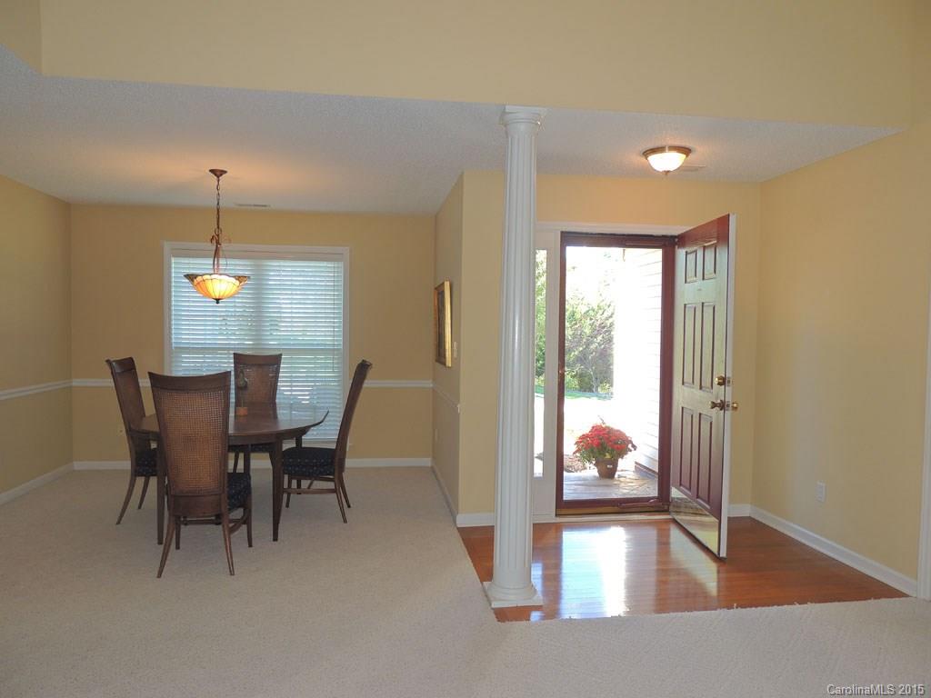 112 Forest Berry Road Fletcher, NC 28732 - Photo 4 of 21 a view of a dining room with furniture wooden floor and a chandelier