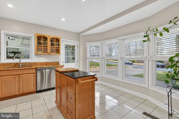 a kitchen with granite countertop a stove and cabinets