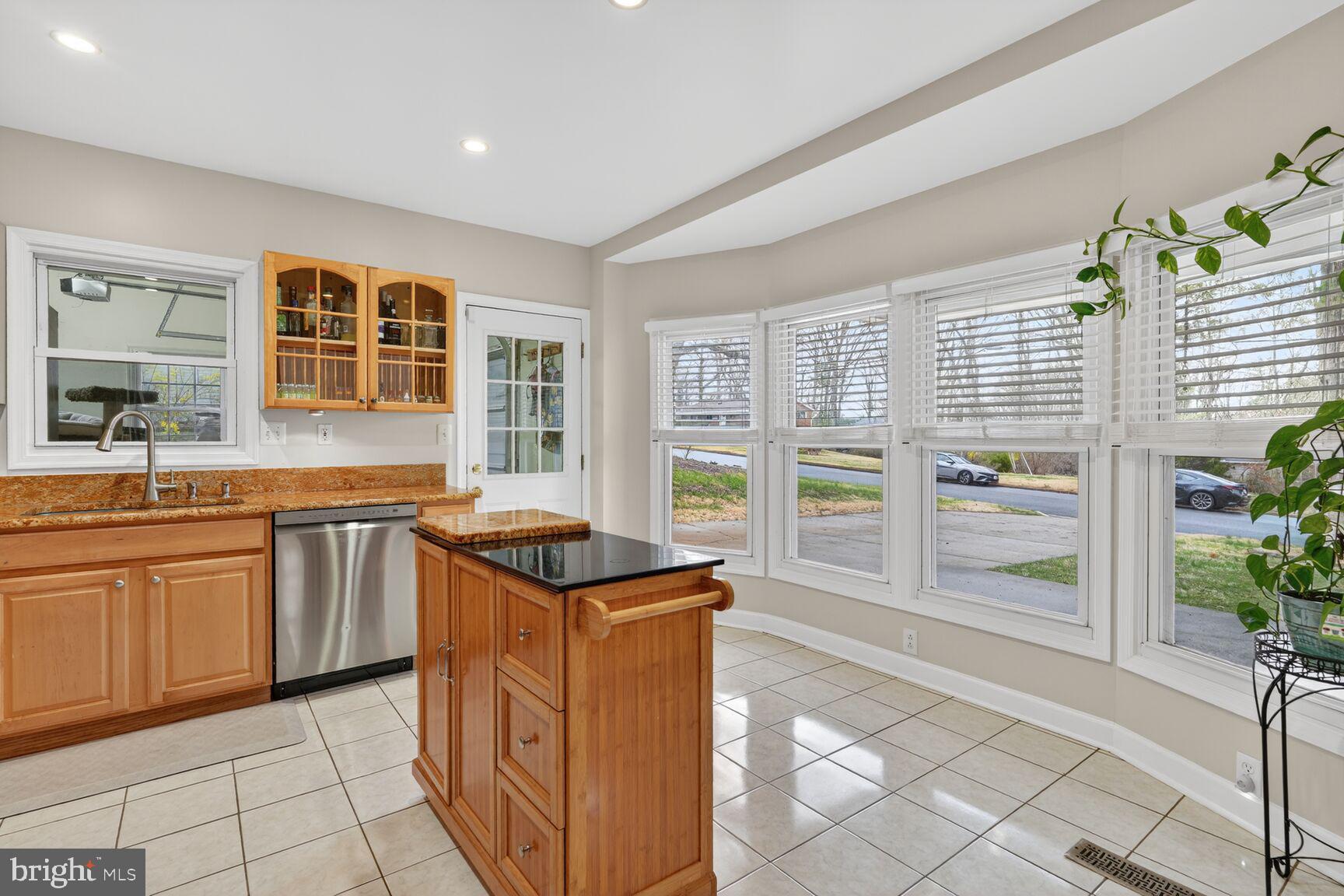 4406 Roundhill Road Alexandria, VA 22310 - Photo 12 of 48 a kitchen with granite countertop a stove and cabinets