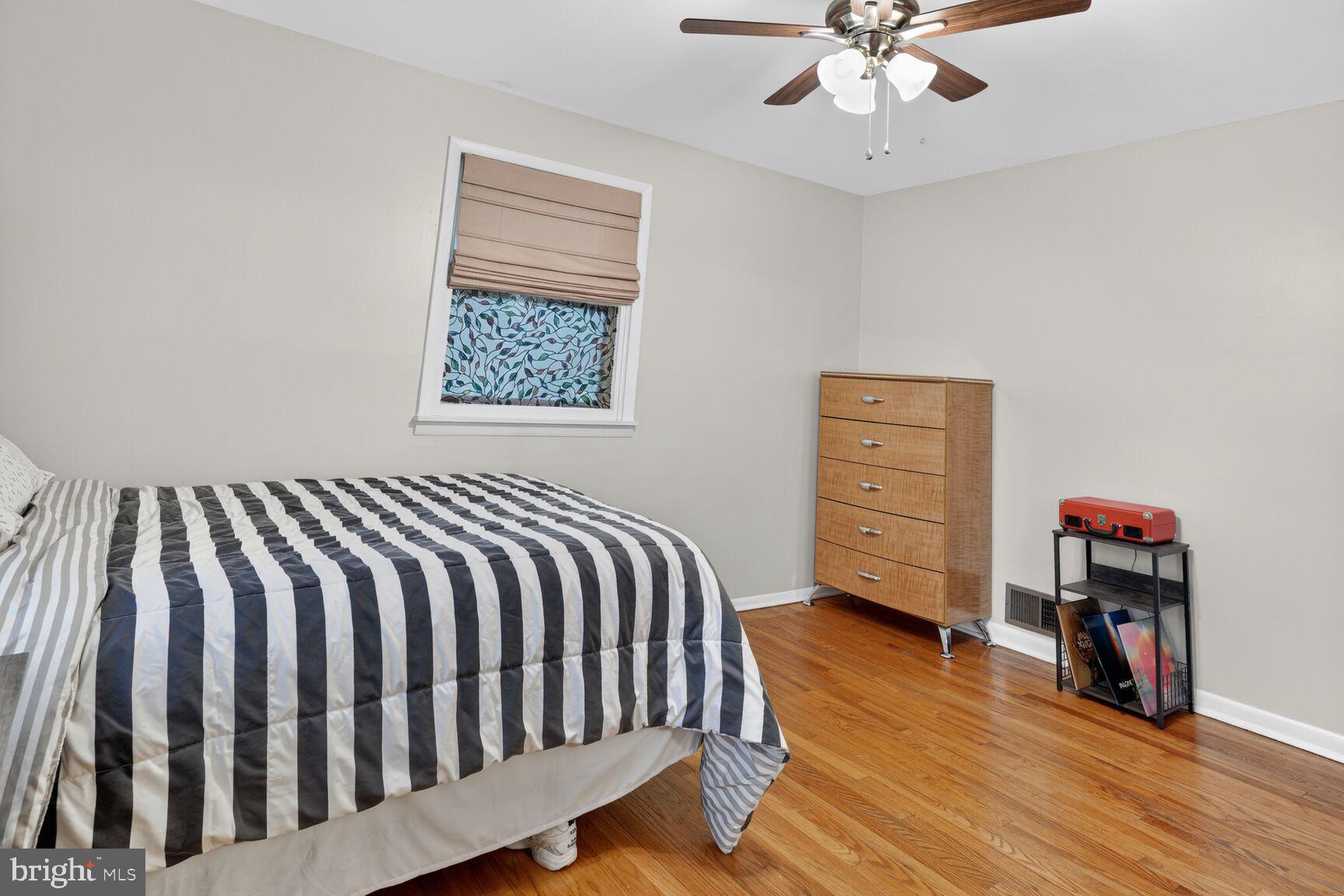 4406 Roundhill Road Alexandria, VA 22310 - Photo 22 of 48 a bedroom with a bed and a chandelier