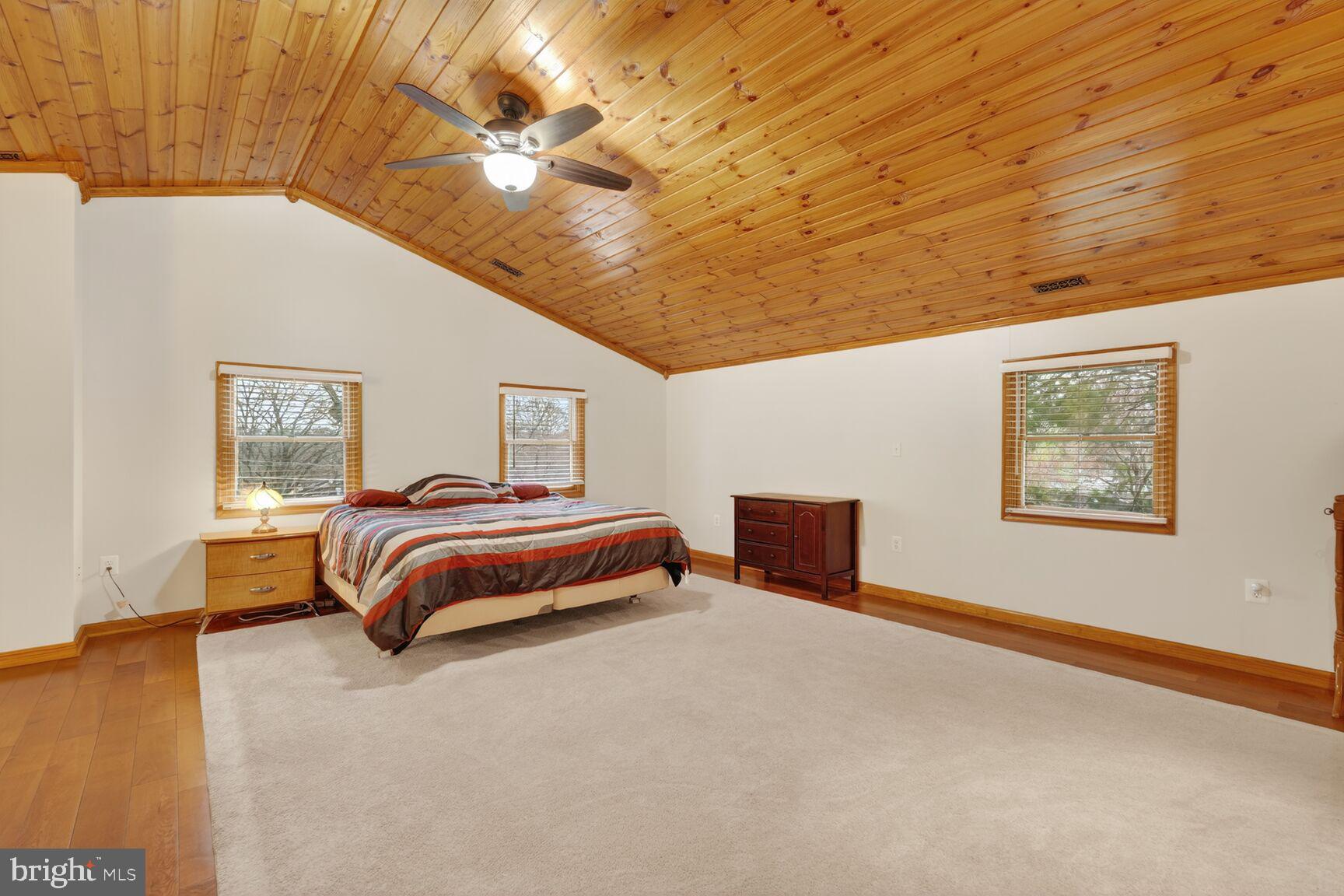 4406 Roundhill Road Alexandria, VA 22310 - Photo 25 of 48 a bedroom with a bed and a chandelier