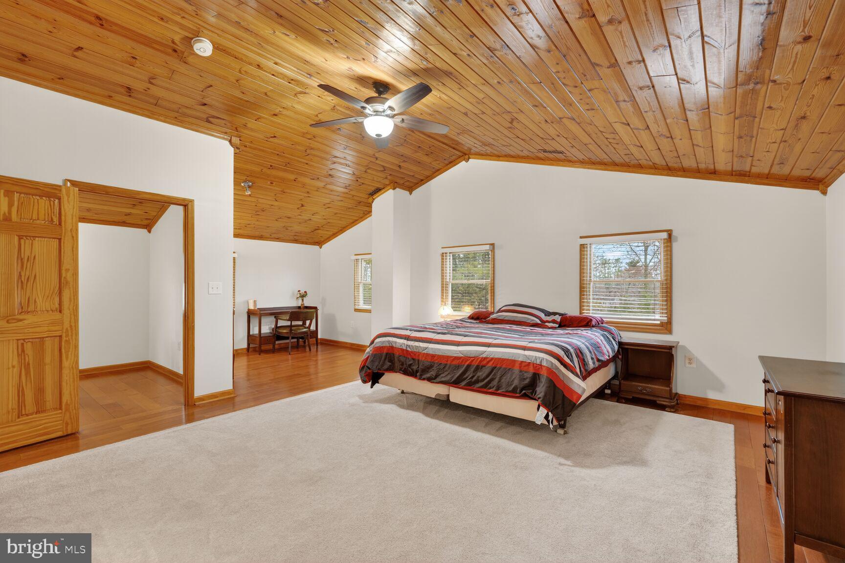 4406 Roundhill Road Alexandria, VA 22310 - Photo 27 of 48 a spacious bedroom with a bed and a chandelier