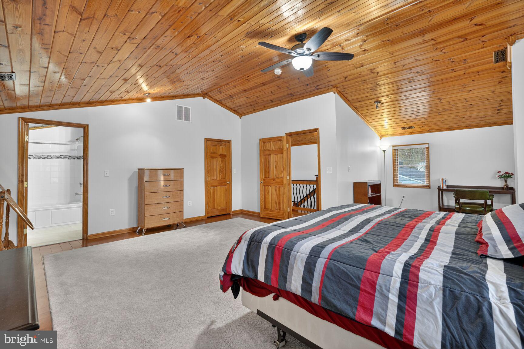 4406 Roundhill Road Alexandria, VA 22310 - Photo 28 of 48 a bed sitting in a spacious bedroom next to a window