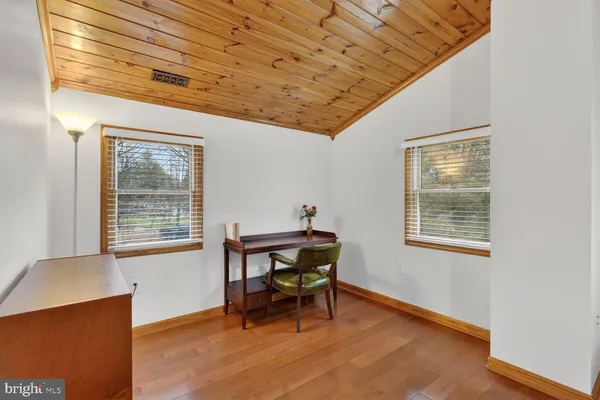 a workspace room with furniture and wooden floor
