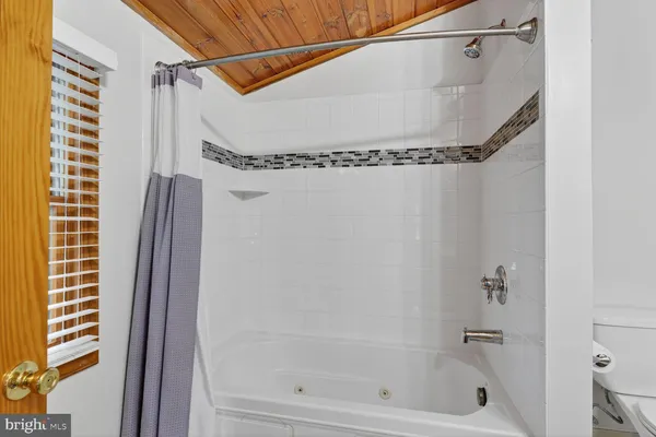 a bathroom with a shower and a shower
