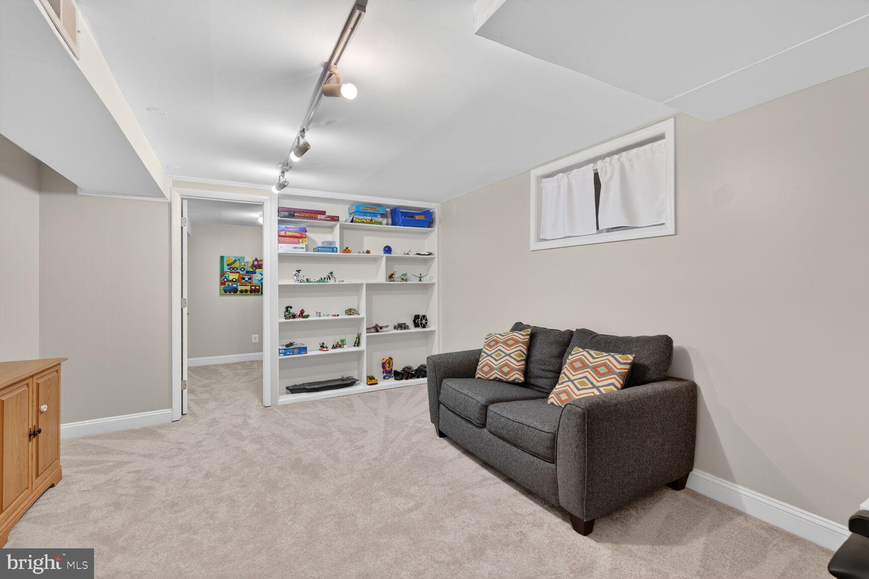 4406 Roundhill Road Alexandria, VA 22310 - Photo 34 of 48 a living room with furniture and a flat screen tv