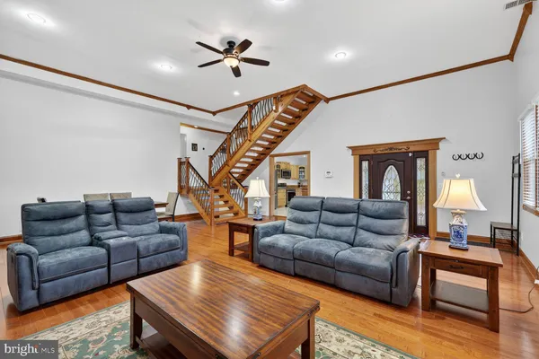 a living room with furniture ceiling fan and a rug