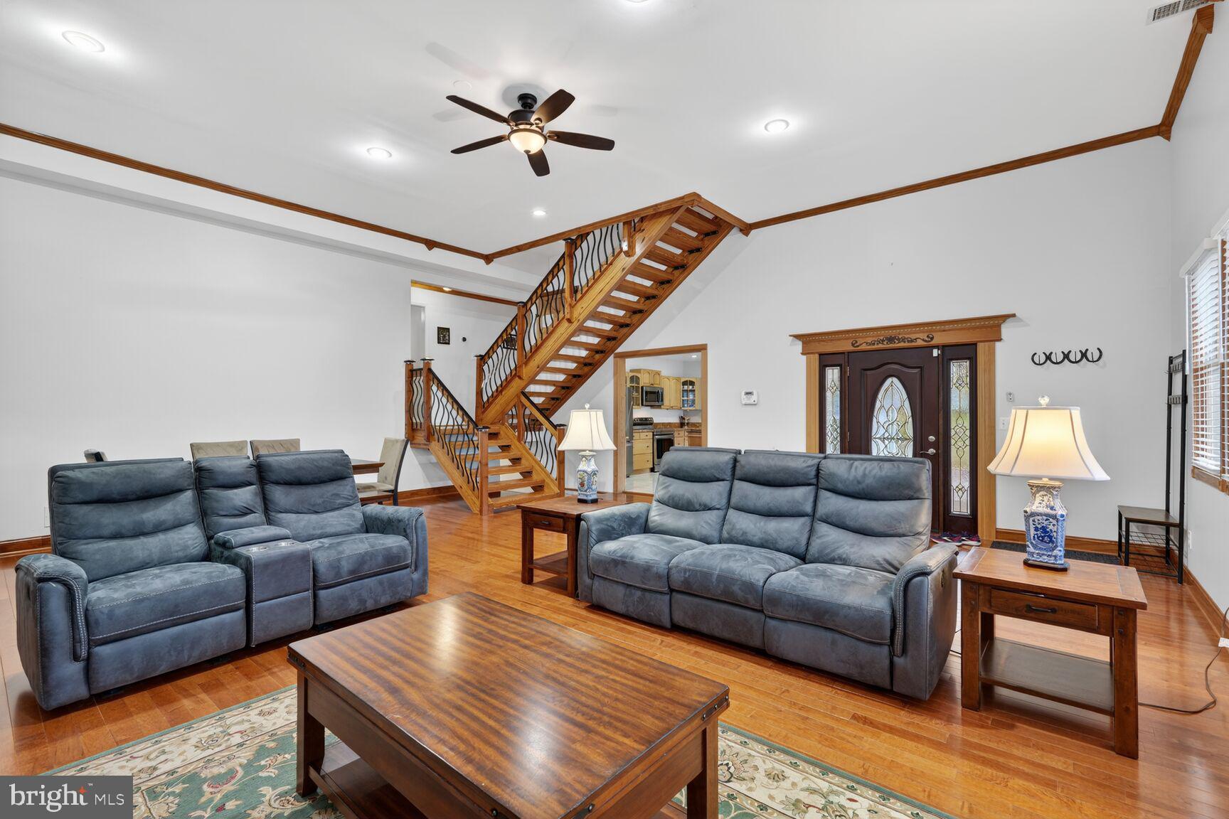 4406 Roundhill Road Alexandria, VA 22310 - Photo 8 of 48 a living room with furniture ceiling fan and a rug