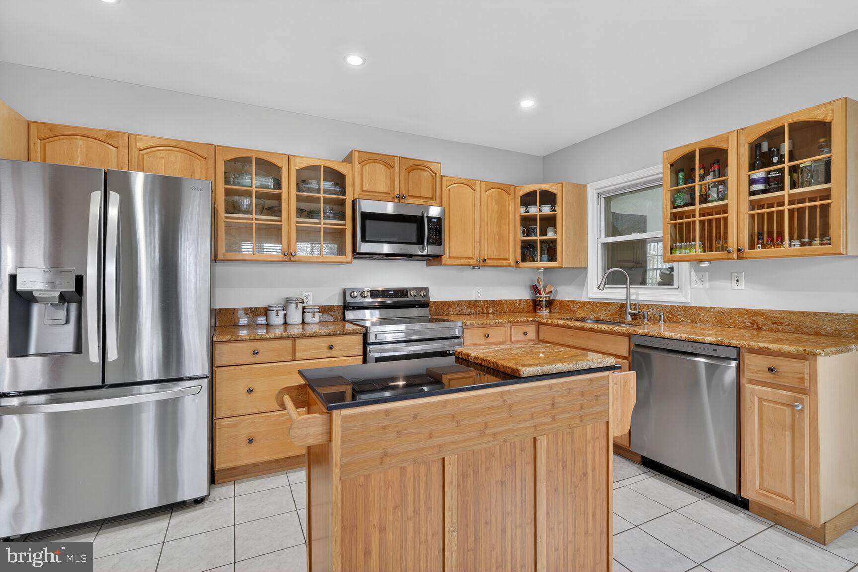 4406 Roundhill Road Alexandria, VA 22310 - Photo 10 of 48 a kitchen with stainless steel appliances granite countertop a stove a sink dishwasher a refrigerator and cabinets with wooden floor
