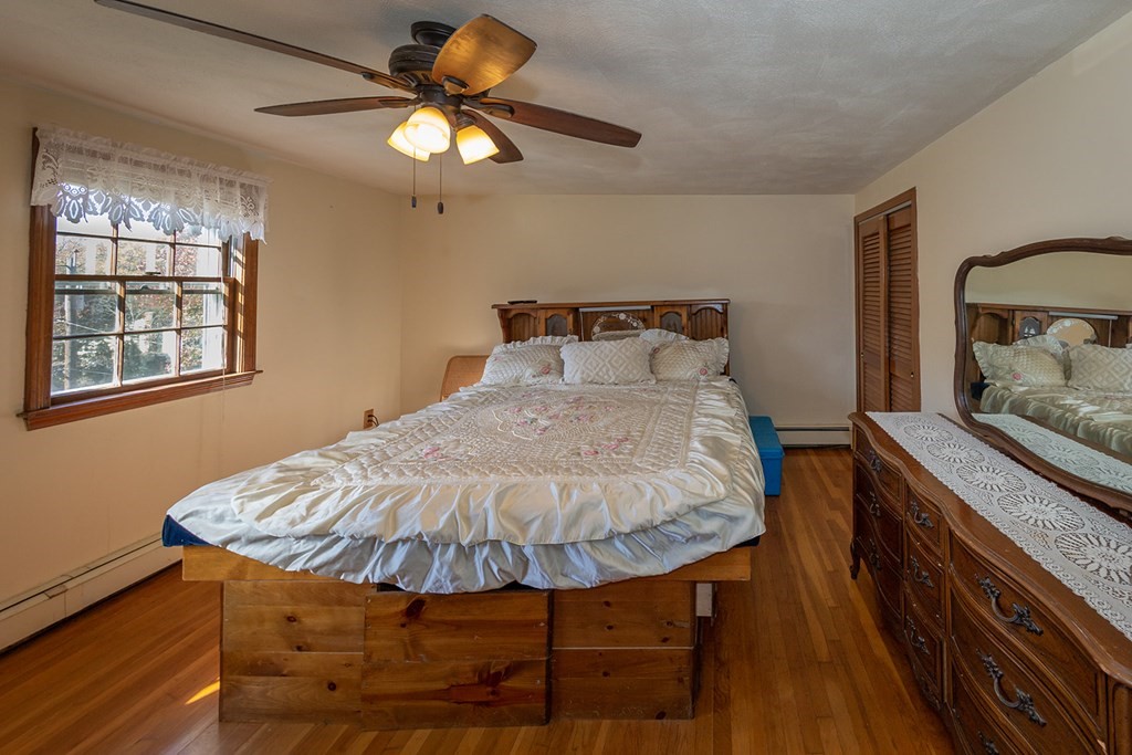 30 Pinewood Road Canton, MA 02021 - Photo 22 of 23 a bedroom with a bed and a chandelier