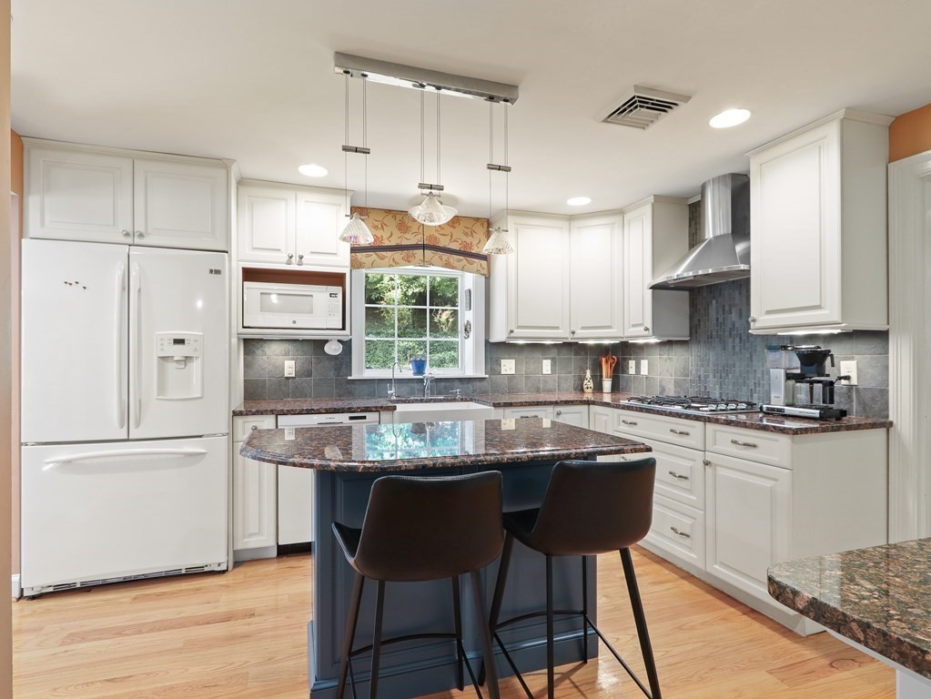 37 Richdale Road Needham, MA 02494 - Photo 5 of 23 a kitchen with stainless steel appliances granite countertop a table chairs sink refrigerator and cabinets