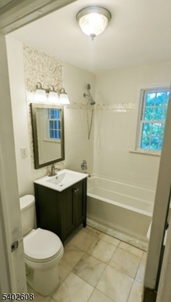 44 Meadowbrook Place Maplewood, NJ 07040 - Photo 4 of 7 a bathroom with a sink toilet and shower