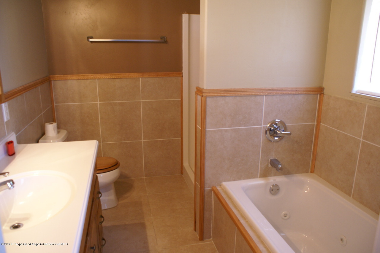 1809 Anvil Court Rifle, CO 81650 - Photo 9 of 11 a bathroom with a tub a sink and a toilet