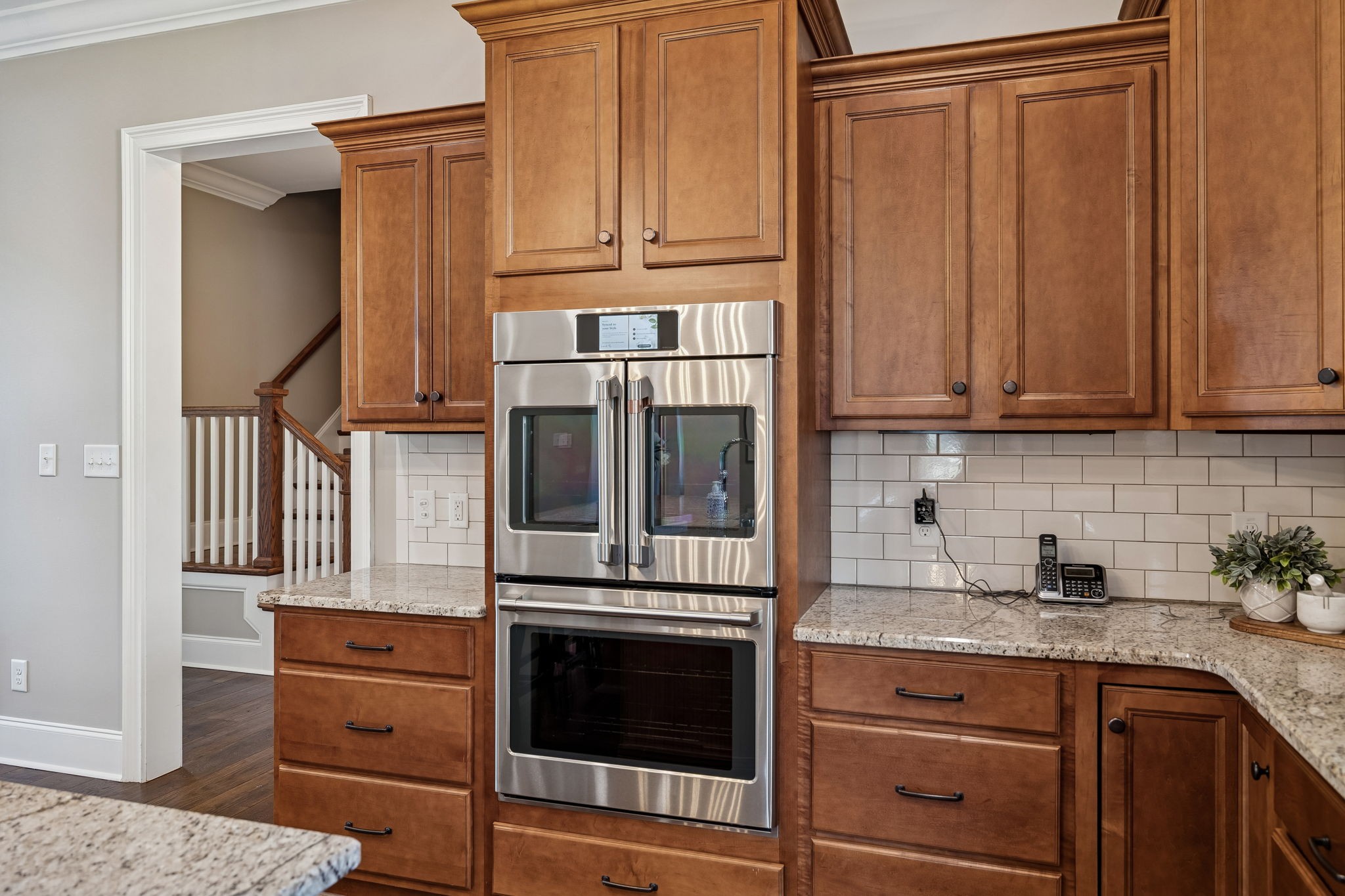 2525 Upper Hollow Road Thompson's Station, TN 37179 - Photo 45 of 79 a kitchen with stainless steel appliances granite countertop a stove and a microwave