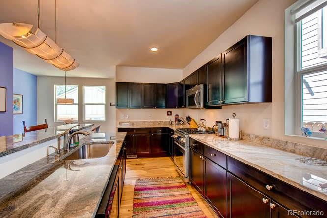 810 East Baseline Road, Unit B Lafayette, CO 80026 - Photo 12 of 28 a kitchen with stainless steel appliances granite countertop a sink stove and cabinets