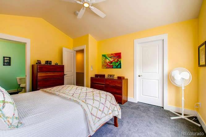 810 East Baseline Road, Unit B Lafayette, CO 80026 - Photo 18 of 28 a bedroom with a bed and a chandelier