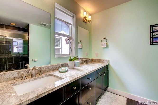810 East Baseline Road, Unit B Lafayette, CO 80026 - Photo 20 of 28 a bathroom with a granite countertop sink and a mirror