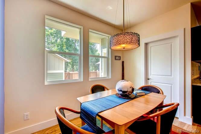 810 East Baseline Road, Unit B Lafayette, CO 80026 - Photo 25 of 28 a dining room with furniture and wooden floor